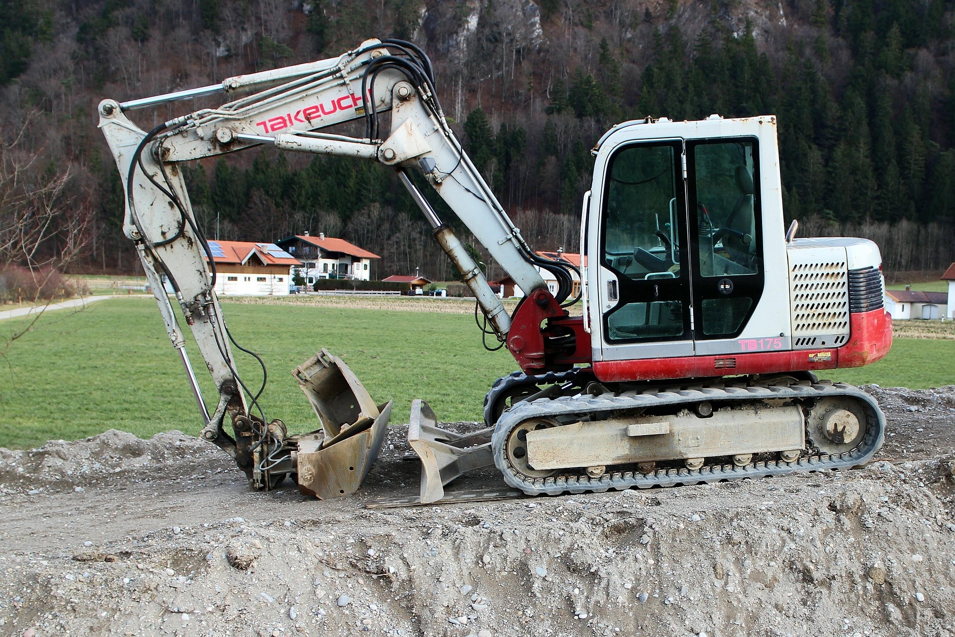 excavator digging hole in yard